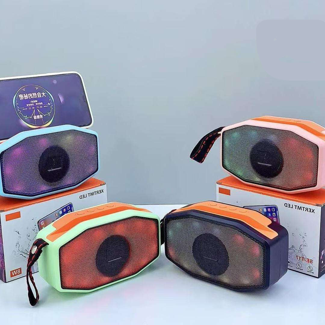 Colorful portable speakers with visible brand logos on a light gray background