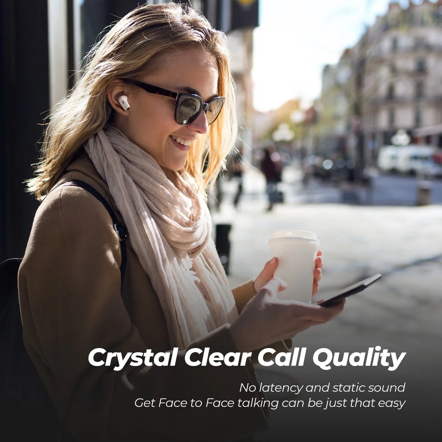 Woman on a city street holding a phone and a cup, with text about crystal clear call quality.
